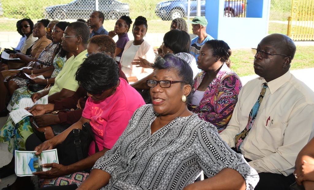 Secretary of RENTAL, Myrtle Ferdinand in black and white blouse 