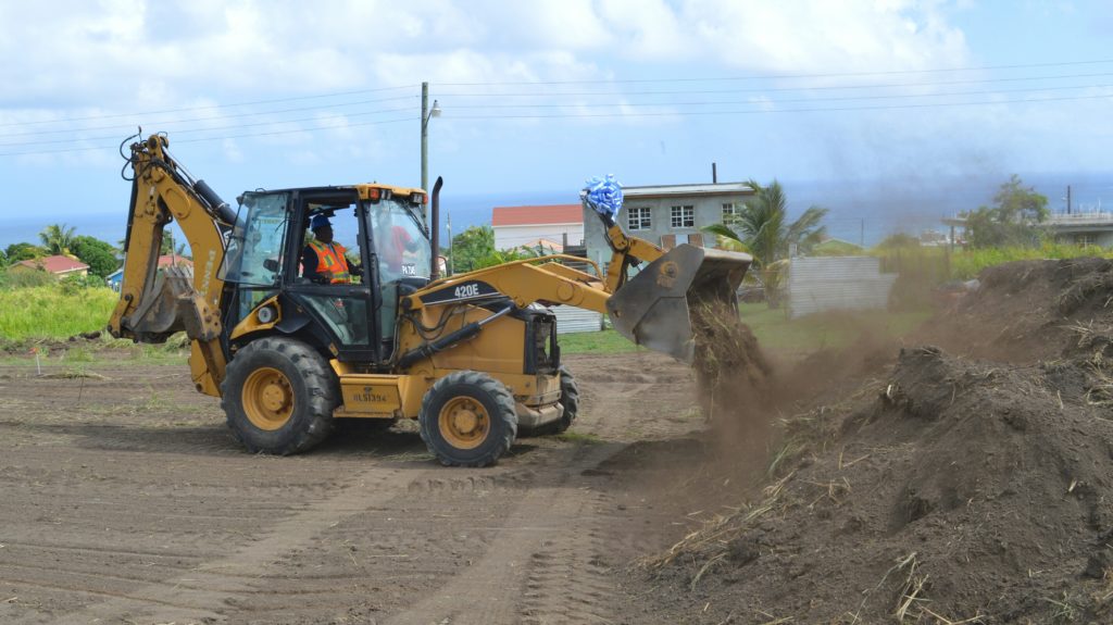 Minister Hamilton operating bulldozer 